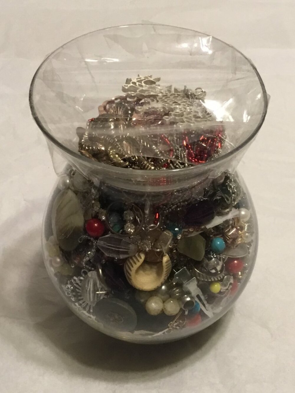 Large and heavy vase filled with old used and broken jewelry